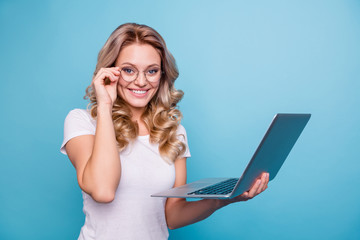 Wall Mural - Portrait of her she nice-looking lovely winsome attractive cheerful cheery wavy-haired lady in casual white t-shirt holding in hand laptop isolated on blue pastel background