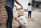 Fototapeta Niebo - Child labor in building commercial building structures. World Labor Day concept