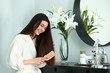 © Pixel-Shot - Beautiful young woman brushing her healthy long hair at home