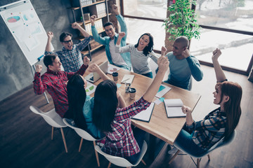 Above high angle view of nice attractive beautiful handsome cheerful executive managers wearing casual sitting rejoice at industrial loft interior workplace workstation open space indoors