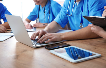 Medical students studying at table, closeup view
