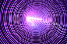 Futuristic Metallic Circular Corridor Illuminated By Purple Light Source Reflected In Shiny Walls.