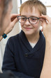 © Ramon Lopez/ADDICTIVE STOCK - Cute young boy trying on glasses in an eyewear store