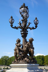 Wall Mural - Alexandre III bridge decorated street lamp with statues in Paris in a sunny summer day, France