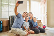 © Joshua Resnick - happy hispanic family taking selfie after moving into new house