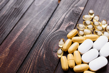 Wall Mural - Pills in the right side of the frame on a dark wooden background