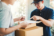 © joyfotoliakid - Customer Man signature in clipboard to receive package from professional delivery man at home