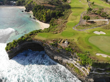 Aerial View Luxury Golf Field Next The Cliff, Ocean And Beach In Bali Island, Indonesia.  Aerial View Of Footpath On Golf Course.