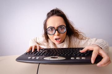 Funny nerd girl working on computer