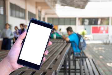 Mobile smart phone with empty white screen mockup on students sitting in school blurred background. Online education technology concept.