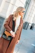 © Galina Zhigalova - Stylish fashionable blonde woman wearing coat and sunglasses, street style photo