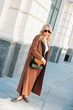 © Galina Zhigalova - Stylish fashionable blonde woman wearing coat and sunglasses, street style photo