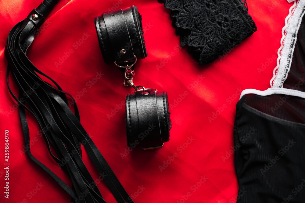 BDSM sex toys for domination and submission. Whip with handcuffs Stock  Photo