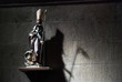 Figure of a bishop throwing a shadow of a grimreaper