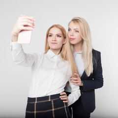 Two friends at work make a selfie on a white background