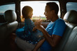 © Odua Images - asian daughter with father in the car playing