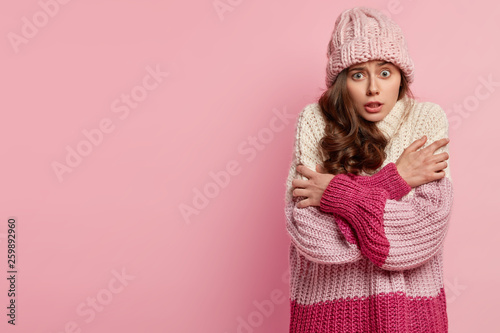 Cuadros en Lienzo Worried European woman trembles with fright, crosses hands over chest, doesnt li