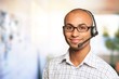 Portrait of a smiling man with headset working as a call center operator