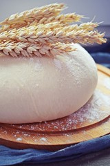 The batter and ears of corn on a wooden Board.