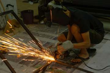 Electric wheel grinding cuting on steel. sparks from cutting