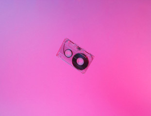 Minimalism retro style concept. 80s. Audio cassette in neon red blue light. Retro wave