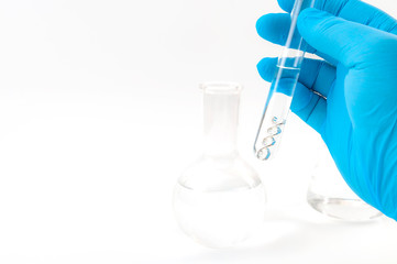 Poster - DNA testing, lab experiment and genetic research concept theme with a scientist holding a double helix molecule in a test tube with blue latex gloves isolated on white background with copy space