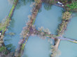 © Unwind - Aerial view of countryside, forest and farm field, lake with houses, Belgium, Bousval