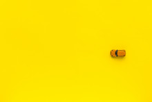 Little Yellow Toy Car On A Yellow Background. Free Space For Text