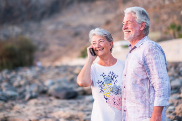 Happy cheerful aged old caucasian couple enjoy and have fun together in outdoor - together forever life concept for beautiful man and woman retired