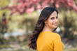 © bnenin - Enjoying spring on a sunny day. Portrait of a young woman outdoors, looking over the shoulder.