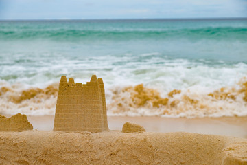 Sand castle on the background of the sea