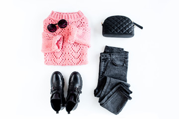 Women fashion clothes and accessories. Feminine youth collage on white background top view. Flat lay female style look with warm sweater, jeans, boot, glasses. Top view.