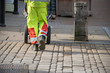 © Paul Rushton - litter collector working for the local council walks along street with barrow for collecting rubbish