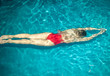 © Sergey Chumakov - sexy woman in red swimsuit swimming under blue water