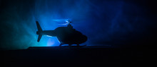 Silhouette Of Military Helicopter Ready To Fly From Conflict Zone. Decorated Night Footage With Helicopter Starting In Desert With Foggy Toned Backlit. Selective Focus.
