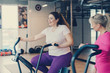 © MZaitsev - Fat woman sits tired on stationary bike