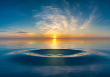Sunset Or Sunrise Over Water Droplet In The Ocean
