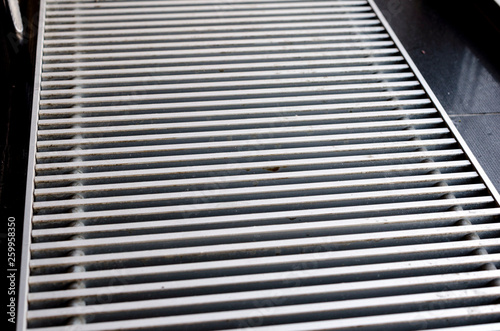 Heating convectors built into the parquet floor. Gray shiny floor radiator  grilles in a glossy wooden finish. Stock Photo | Adobe Stock