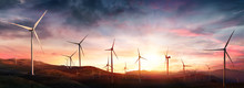 Wind Turbines In Rural Landscape At Sunset