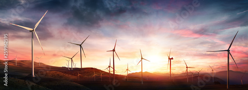 Fotografía Wind Turbines In Rural Landscape At Sunset
