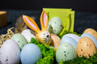 Easter bunny with colorful easter eggs in basket