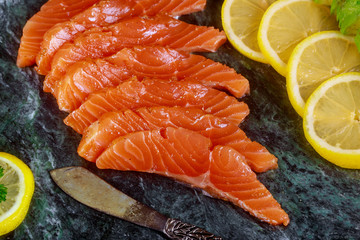 Wall Mural - Freshly salmon with lime, avocado on a marble plate horizontal