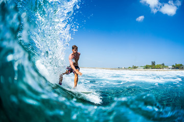 Wall Mural - Surfer rides barreling tropical ocean wave