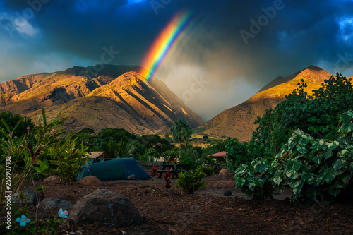 Fotografía Rainbow over the mountains and tent set in the camping