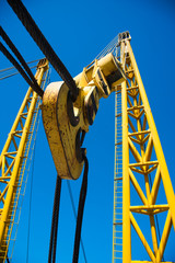 Wall Mural - Loading in port. Floating port crane on blue sky background