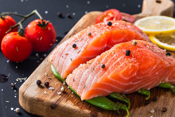 diet healthy food concept, raw fresh salmon fillet and ingredients on wooden background