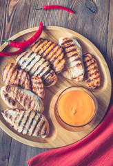 Wall Mural - Grilled chicken breast on the wooden tray