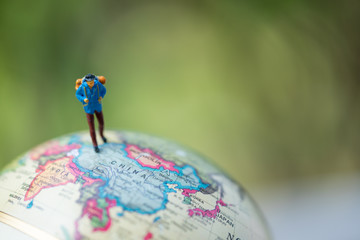 Wall Mural -  Miniature people: group of traveler on earth globe ,traveling around the world,  exploring on earth background concept.