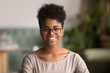 Leinwandbild Motiv Headshot portrait of happy mixed race african girl wearing glasses