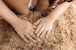 Leinwandbild Motiv Children's hands playing sand at beach